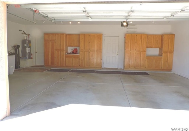 2353 Halfmoon Way, Bullhead City, AZ 86442 - garage with a garage door opener and electric water heater