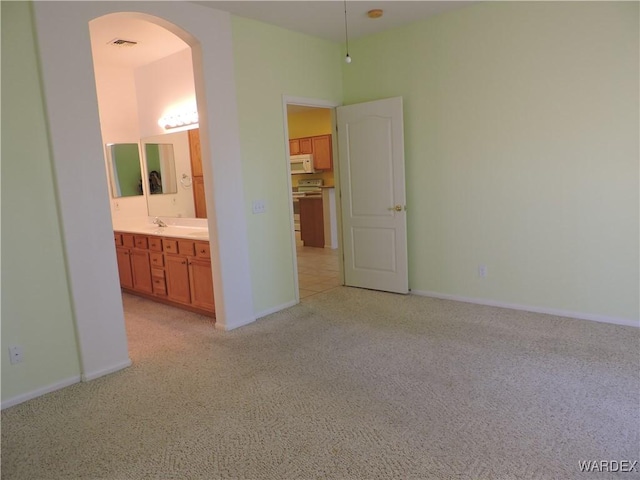 2353 Halfmoon Way, Bullhead City, AZ 86442 - unfurnished room with visible vents, arched walkways, baseboards, and light carpet