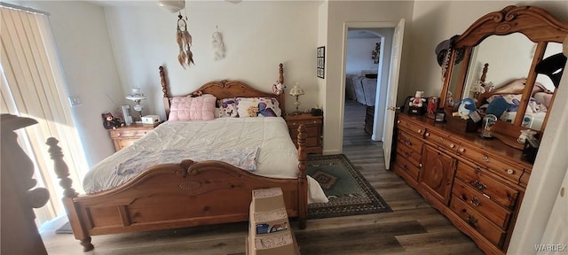 bedroom with dark wood-type flooring