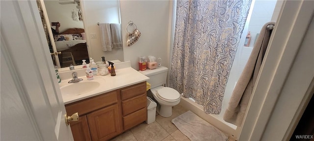 ensuite bathroom featuring a ceiling fan, toilet, ensuite bath, tile patterned flooring, and vanity