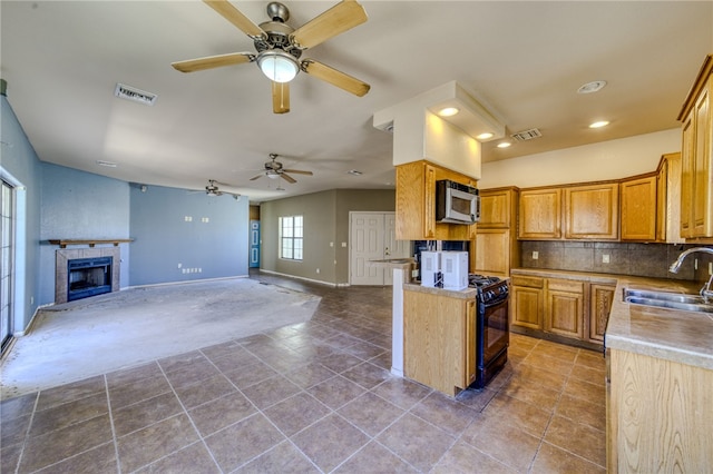 2230 Diamond Creek Rd, Bullhead City, AZ 86442 - kitchen with stainless steel microwave, a ceiling fan, black range with gas cooktop, open floor plan, and tile patterned floors