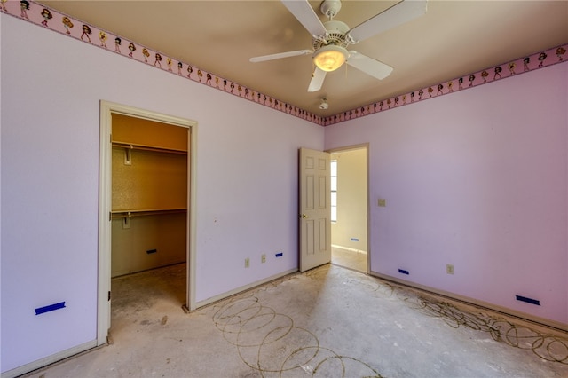 2230 Diamond Creek Rd, Bullhead City, AZ 86442 - unfurnished bedroom with unfinished concrete floors, a walk in closet, and ceiling fan