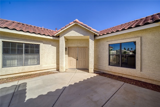 2230 Diamond Creek Rd, Bullhead City, AZ 86442 - entrance to property featuring a patio, stucco siding, and a tile roof