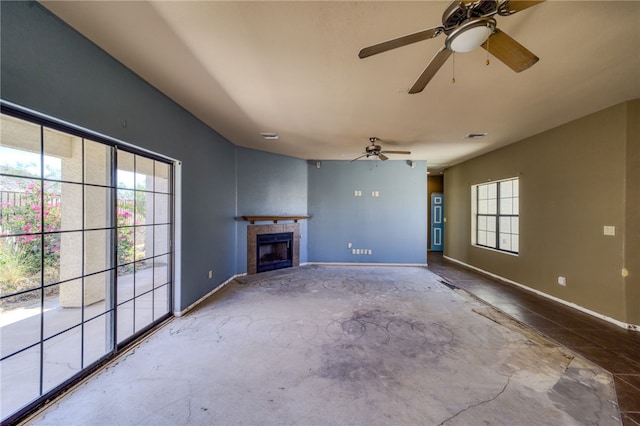 2230 Diamond Creek Rd, Bullhead City, AZ 86442 - unfurnished living room featuring unfinished concrete floors, ceiling fan, and a fireplace
