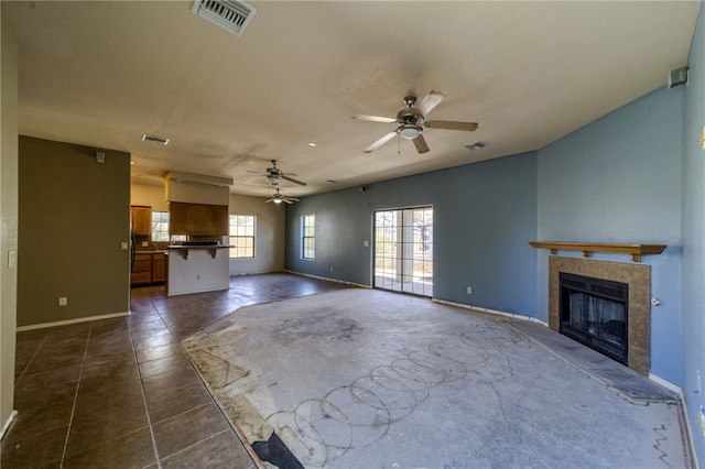 2230 Diamond Creek Rd, Bullhead City, AZ 86442 - unfurnished living room featuring a tiled fireplace and a ceiling fan