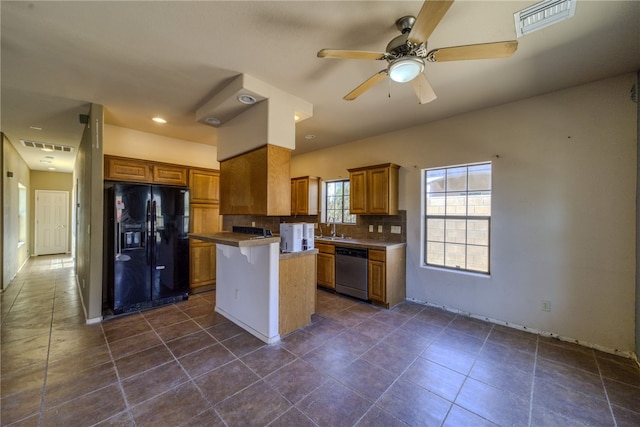 2230 Diamond Creek Rd, Bullhead City, AZ 86442 - kitchen with black fridge, stainless steel dishwasher, brown cabinetry, and backsplash
