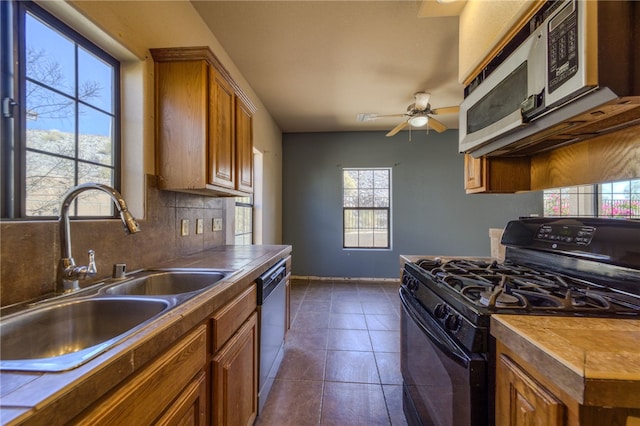 2230 Diamond Creek Rd, Bullhead City, AZ 86442 - kitchen featuring gas stove, plenty of natural light, and brown cabinets