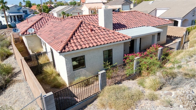 2230 Diamond Creek Rd, Bullhead City, AZ 86442 - view of side of property with a tiled roof, a residential view, a chimney, and stucco siding