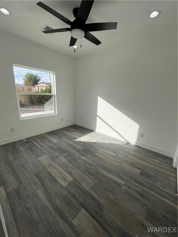 unfurnished room featuring a ceiling fan, recessed lighting, dark wood finished floors, and baseboards