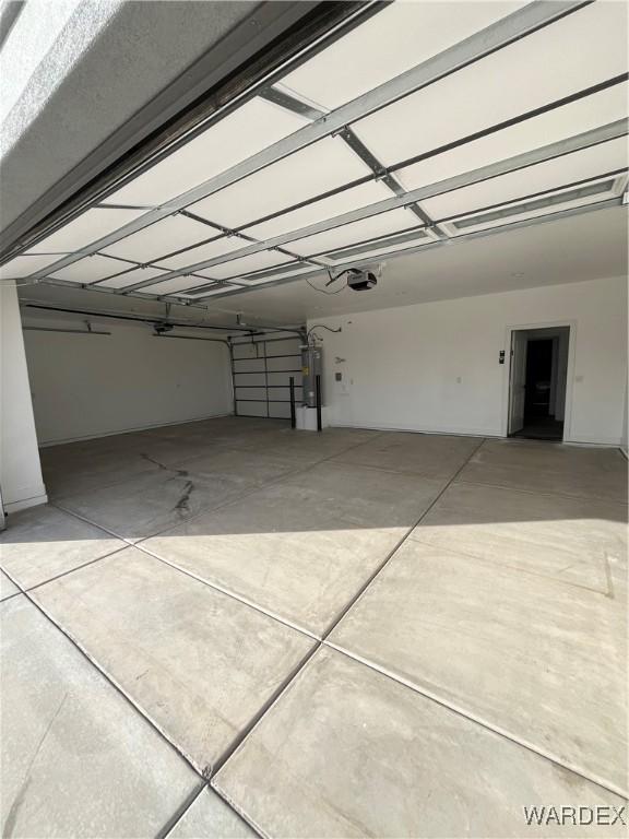 garage with water heater and a garage door opener