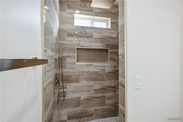 bathroom with a tile shower