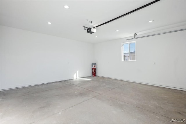 garage with recessed lighting and a garage door opener