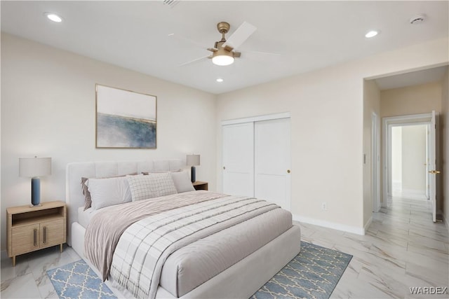 bedroom with marble finish floor, recessed lighting, and baseboards