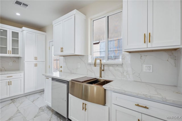 kitchen featuring marble finish floor, visible vents, glass insert cabinets, white cabinets, and a sink