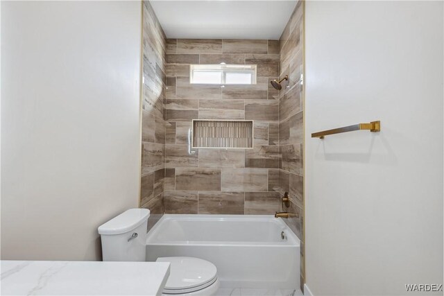 bathroom with tub / shower combination, vanity, and toilet