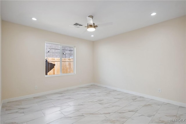 spare room featuring marble finish floor, visible vents, ceiling fan, and baseboards