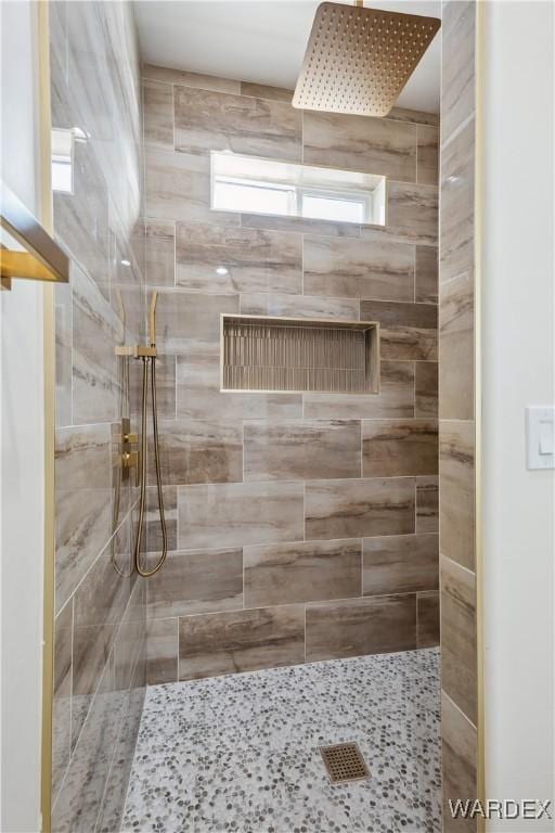 bathroom with tiled shower