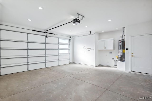 garage featuring a garage door opener, recessed lighting, and gas water heater