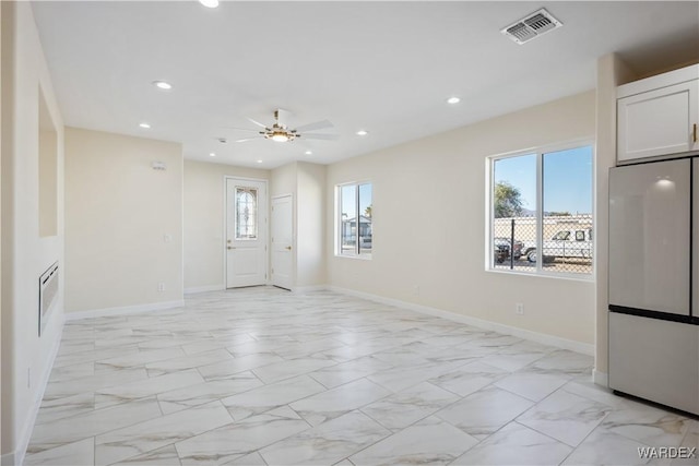 empty room featuring marble finish floor, baseboards, visible vents, and recessed lighting