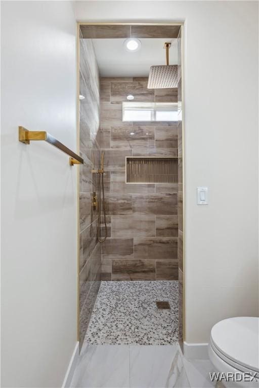 full bathroom with walk in shower, toilet, and baseboards