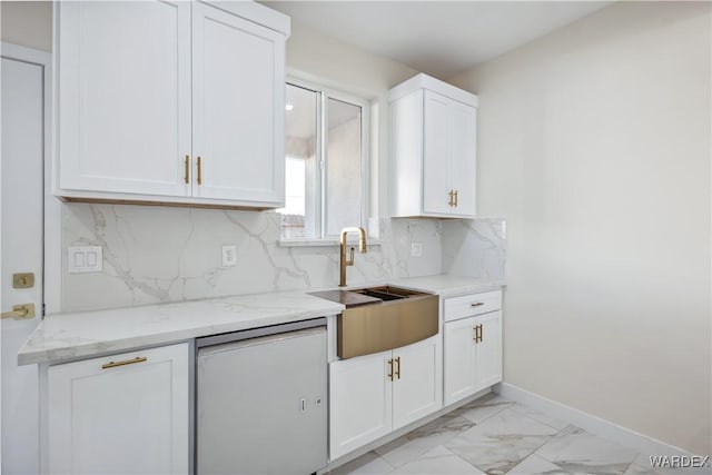 kitchen with a sink, white cabinets, marble finish floor, light stone countertops, and tasteful backsplash