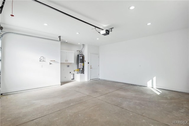 garage with a garage door opener, recessed lighting, and water heater