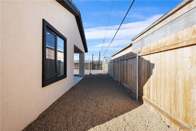 view of home's exterior featuring fence and stucco siding