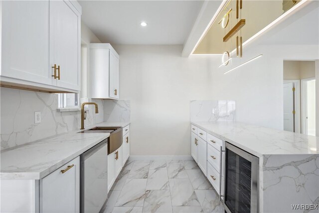 kitchen featuring stainless steel dishwasher, wine cooler, white cabinetry, and light stone counters