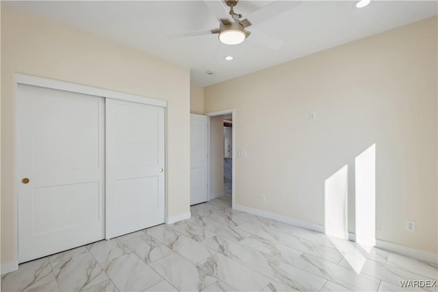 unfurnished bedroom featuring baseboards, ceiling fan, marble finish floor, a closet, and recessed lighting