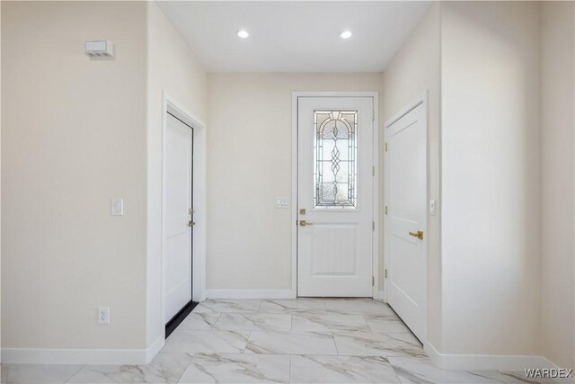 entrance foyer featuring marble finish floor, baseboards, and recessed lighting