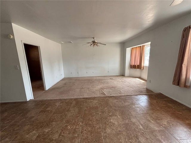 unfurnished room with baseboards and ceiling fan