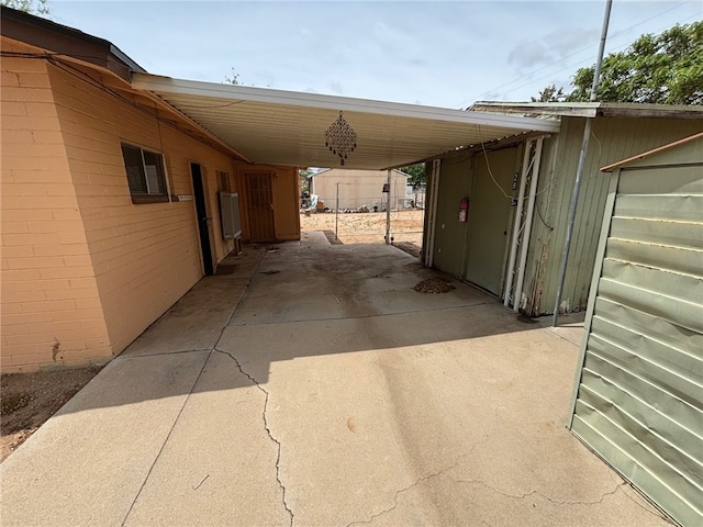 view of car parking with driveway and a carport