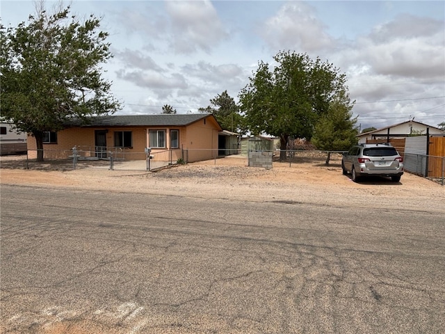 view of front of house with a fenced front yard and a gate