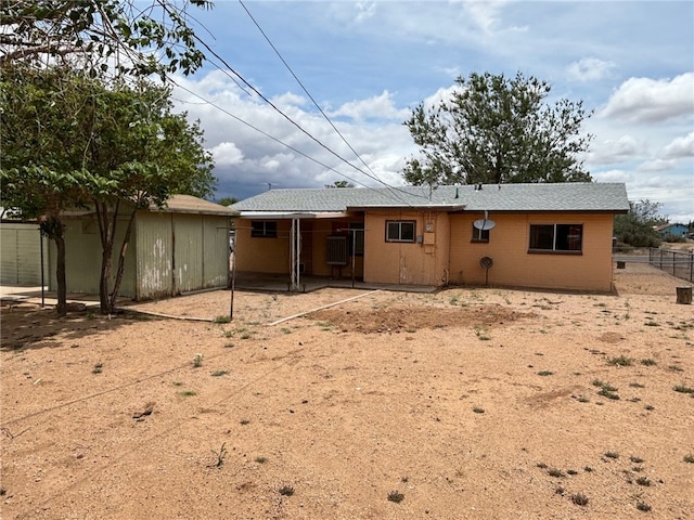 rear view of property featuring fence