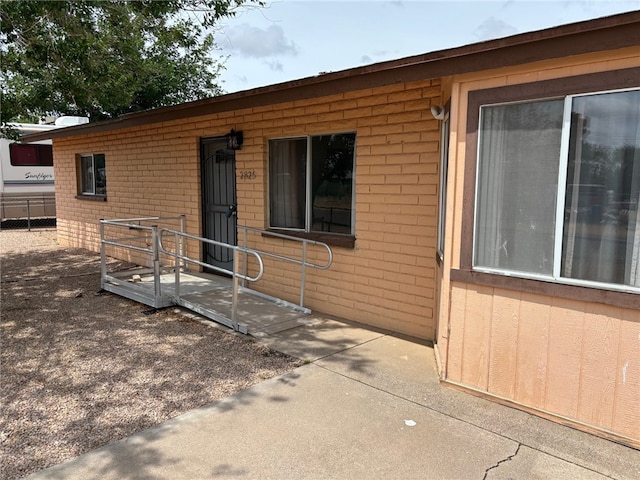 property entrance featuring brick siding
