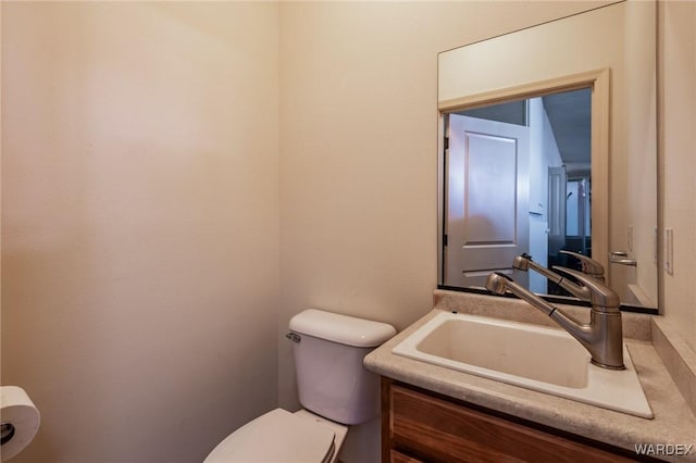 half bath with vanity and toilet