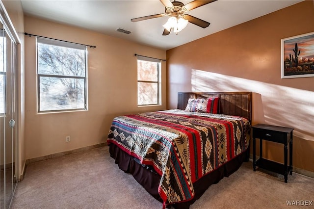 bedroom with carpet, multiple windows, visible vents, and baseboards