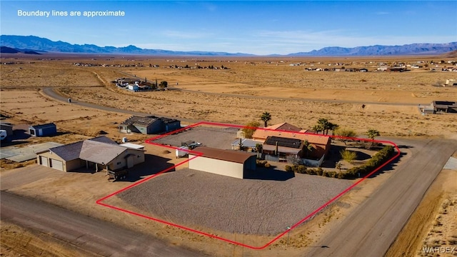 aerial view featuring a desert view, a rural view, and a mountain view