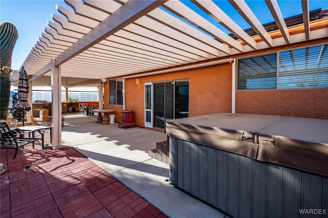 view of patio / terrace with outdoor dining space, a pergola, and a hot tub