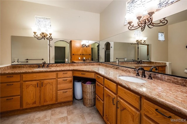 full bathroom with a chandelier and vanity