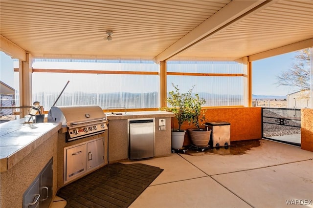 view of patio featuring exterior kitchen and area for grilling