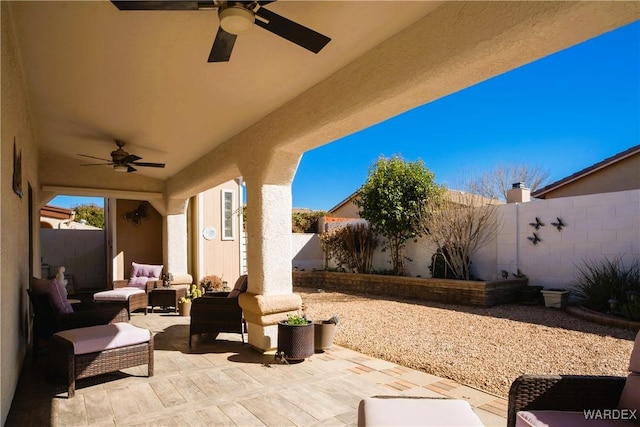 view of patio / terrace featuring a fenced backyard, ceiling fan, and an outdoor living space