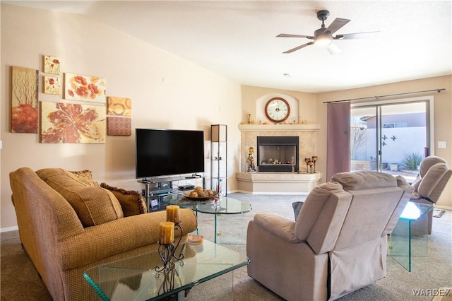 living area featuring carpet floors, a ceiling fan, baseboards, and a premium fireplace