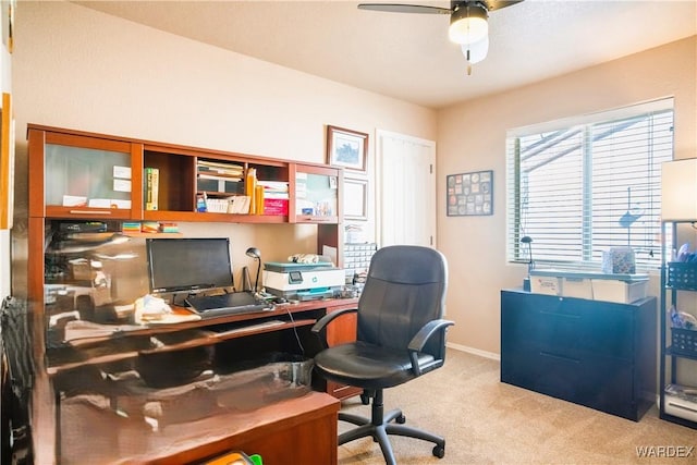 office area featuring baseboards, a ceiling fan, and carpet flooring