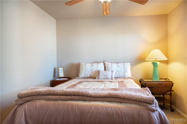 carpeted bedroom featuring a ceiling fan and baseboards