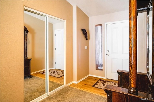 entrance foyer featuring baseboards and wood finished floors