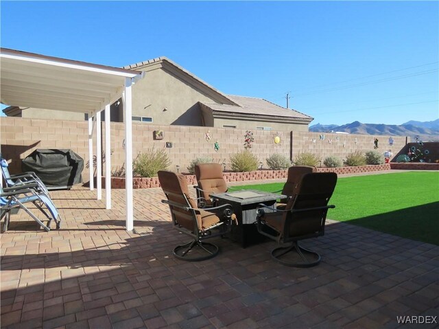 view of patio with a fenced backyard and a mountain view