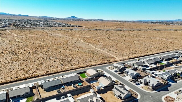 bird's eye view featuring a residential view, a desert view, and a mountain view