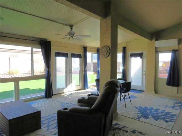 interior space with a wall unit AC, vaulted ceiling, a ceiling fan, and french doors