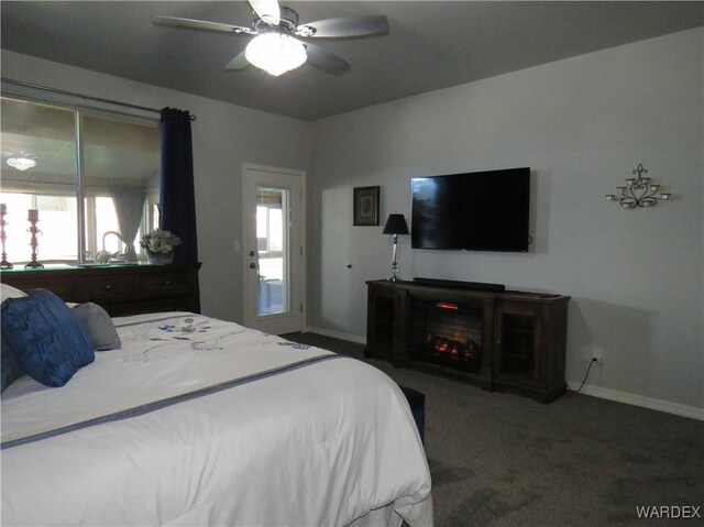 bedroom featuring carpet, multiple windows, baseboards, and a fireplace